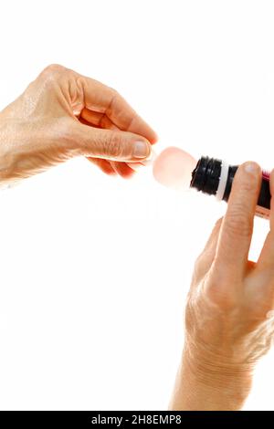 Dosing cough syrup with a spoon on white background Stock Photo