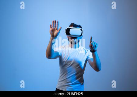 Modern architect, designer using virtual reality glasses at workplace. Designer working in augmented reality vr studio. Man working in VR goggles on a Stock Photo