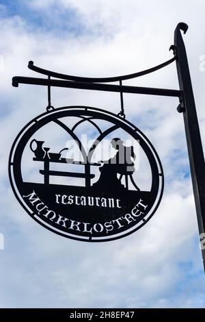 Vadstena, Sweden - May 23, 2021; A round sign in front of monastery hotel in famous tourist Swedish town Stock Photo