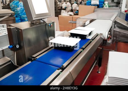 Chicken fillet production line . Factory for the production of food from meat.Modern poultry processing plant.Conveyor Belt Food.The meat factory. Stock Photo