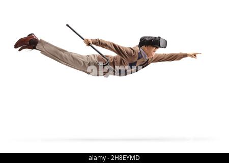 Elderly man with a vr headset flying and pointing isolated on white background Stock Photo