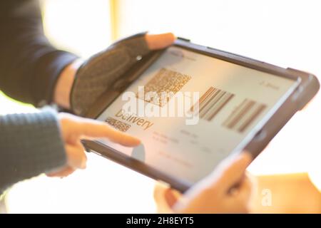 Close up delivery barcode on digital tablet screen Stock Photo