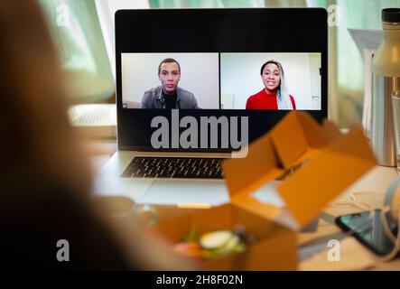 POV colleagues video chatting on laptop screen Stock Photo