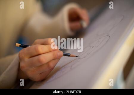 Close up female architect with pencil drafting blueprint Stock Photo
