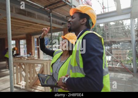 Engineers talking at construction site Stock Photo