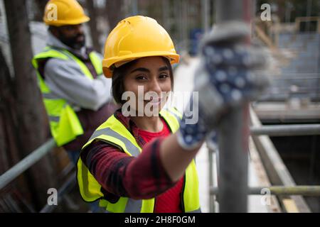 Portrait confident female construction worker at construction site Stock Photo