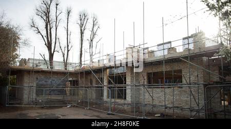 Scaffolding over brick house under construction Stock Photo