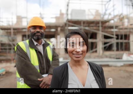 Portrait confident engineer and forewoman at construction site Stock Photo