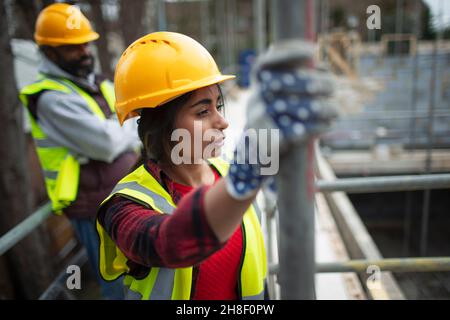 Thoughtful female construction worker at construction site Stock Photo