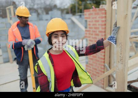 Portrait confident female construction worker at construction site Stock Photo