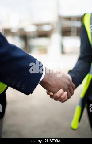 Close up engineers shaking hands Stock Photo