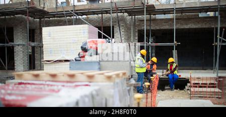 Construction workers on lunch break at construction site Stock Photo