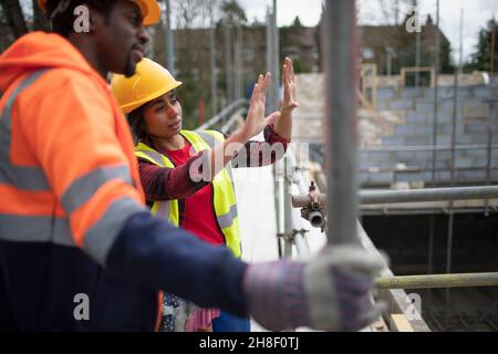 Construction workers talking at construction site Stock Photo