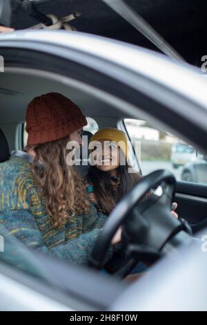 Happy young couple enjoying road trip in car Stock Photo