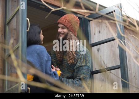 Happy young couple talking in cabin window Stock Photo
