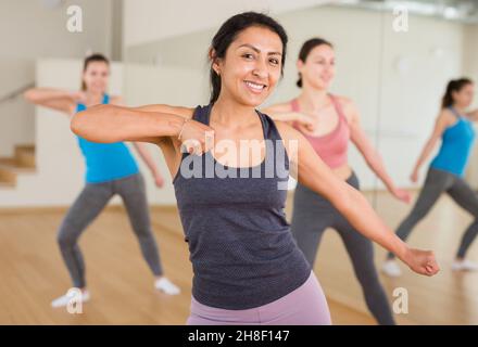 Portrait of young smiling hispanic woman dancing Stock Photo