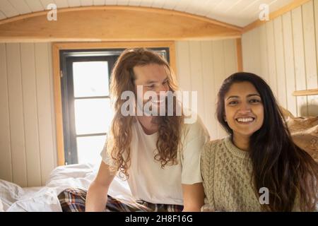 Portrait happy young couple in bed Stock Photo