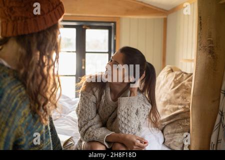 Young couple talking in tiny cabin rental Stock Photo