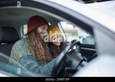 Smiling young couple inside car Stock Photo