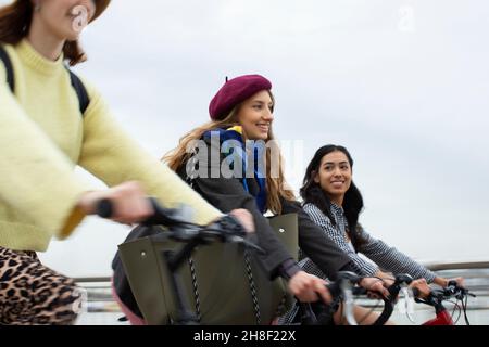 Young women friends riding bicycles Stock Photo