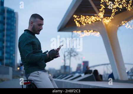 Man using smart phone in city at night Stock Photo