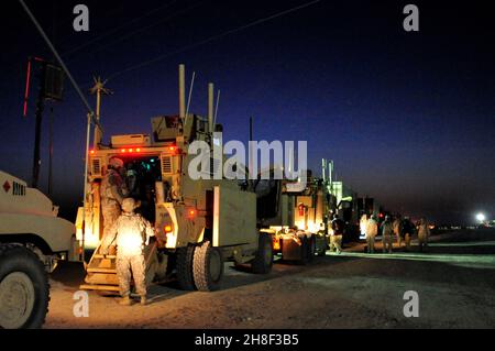 MRAP armored vehicles with the 4th Stryker Brigade, 2nd Infantry Division, carry the last remaining U.S. military forces as they drive across the Iraqi border from Iraq to Kuwait December 18, 2011 at K-Crossing, Kuwait. Stock Photo