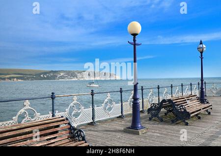 View from Swanage Pier looking across Swanage Bay towards chalk cliffs of Ballard Down and Ballard Point with Old Harry Rocks, Dorset, England, UK Stock Photo