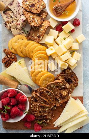 Cheese board or snack board with crackers Stock Photo