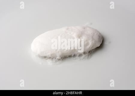 white soap with foam, isolated on a neutral gray background, mockup template for graphic designing Stock Photo