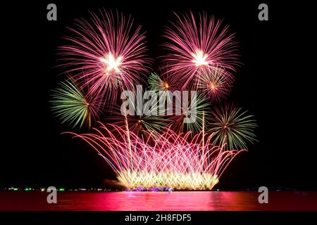 Colorful fireworks celebration from the sea with the midnight sky ...