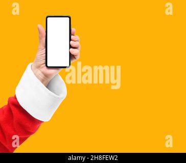Santa show smart phone with blank screen isolated on orange yellow background Stock Photo