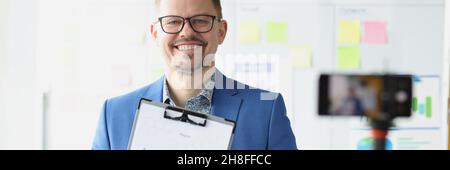 Male mentor conducts online business development training Stock Photo