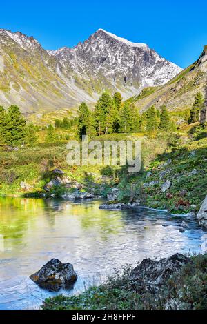 August morning in the Siberian mountains. Ice plates on surface of lake. Eastern Sayan Mountains. Buryatia. Russia Stock Photo