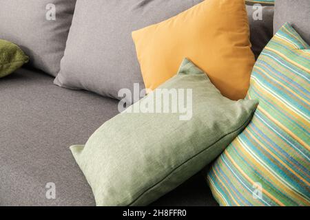 Few Elegant and Decorative Pillows on a Sofa Bed Inside a Room. Close Up Photo. Stock Photo