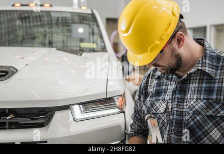 Hard Hat Construction Site Worker in Front of Pickup Truck Preparing Himself For Another Day in Construction Job Stock Photo