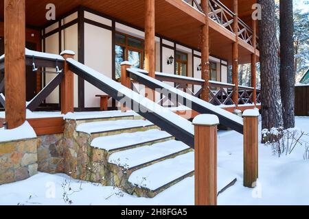 Porch of a large house in the snow. On a sunny day after a snowfall Stock Photo