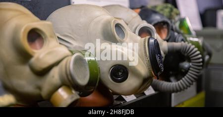 Different Set gas mask are in row on black background. Stock Photo