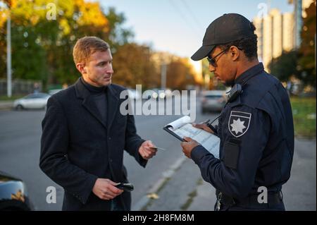 Police checking the driver's license from driver Stock Photo