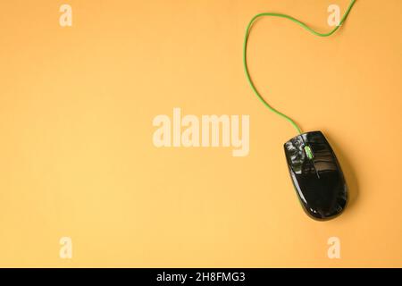 Computer mouse on yellow tabletop. Copy space. Stock Photo