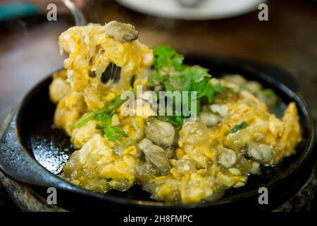 Close up of Raw Oysters fried in egg batter hot pan, focus selective Stock Photo