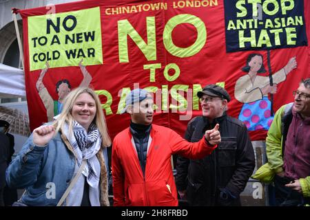 Activists gesture as they take part during the Anti-Asian Hate rally. Dozens of pro democracy, pro Hong Kong independence and anti CCP (Chinese Communist Party) protesters hosted a  counter protest against the Stop Anti-Asian Hate rally 'against the new cold war' organized by the Chinese associations in the UK, in London's Chinatown. Stock Photo