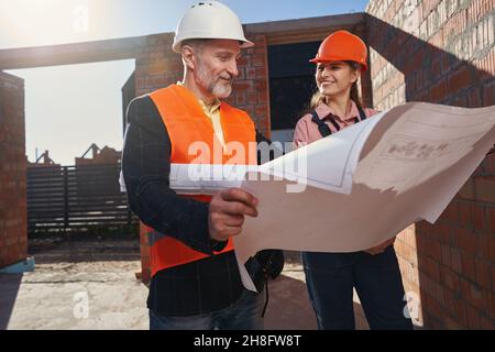Two certified engineers looking happy about the building process Stock Photo