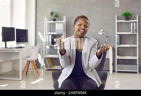 Millennial ethnic woman speak on video call in office Stock Photo