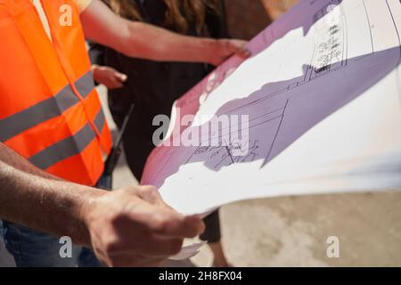 Fragment photo of building plans in hands of engineer Stock Photo