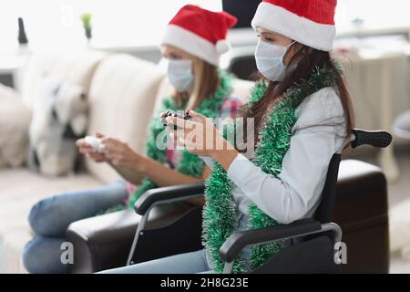 Young women playing video game for fun using controlling joystick Stock Photo