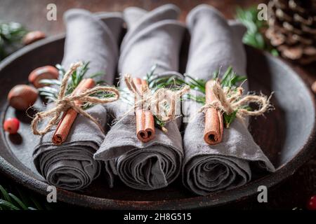 Handmade Christmas table setting with gingerbread cookies and napkin on wooden table Stock Photo