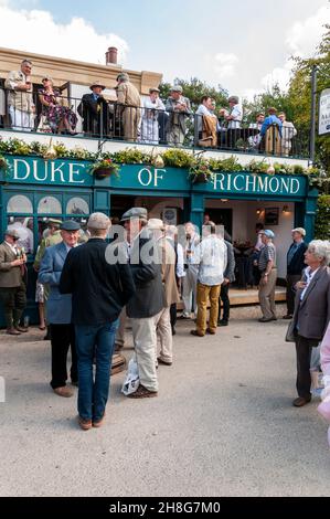 Re-creation of a Duke of Richmond pub at the Goodwood Revival vintage event 2014. Visitors drinking Stock Photo