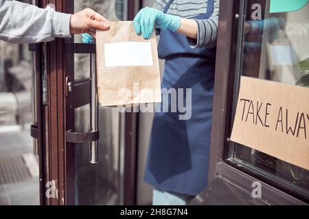 Woman waitress serving customer in coffee shop Stock Photo