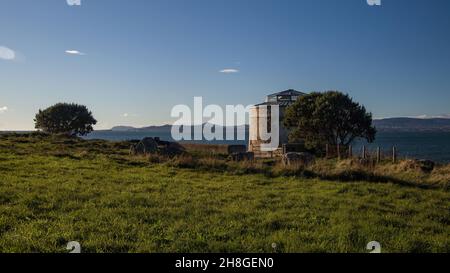 Martello Tower Sutton at The Peninsula of Howth Head in sunny day with blue sky above, Dublin, Ireland Stock Photo