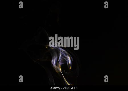 Colored smoke on a black background, abstract backdrop Stock Photo